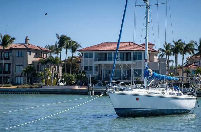 Tipsea Gypsea, a 45-foot Catalina sailboat, lies beached on a sandbar near the Harbor Acres neighborhood, posing a risk to the neighborhood’s seawall and dozens of nearby moored boats. Sarasota Police Department Marine Patrol Officer Michael Skinner said the registered owner is working to get a specialized bolt to re-attach the steering wheel.