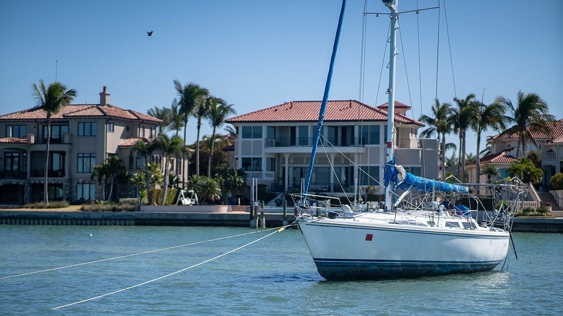 Tipsea Gypsea, a 45-foot Catalina sailboat, lies beached on a sandbar near the Harbor Acres neighborhood, posing a risk to the neighborhood’s seawall and dozens of nearby moored boats. Sarasota Police Department Marine Patrol Officer Michael Skinner said the registered owner is working to get a specialized bolt to re-attach the steering wheel.