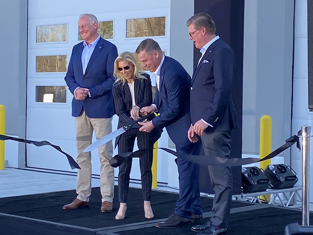 The ribbon is cut Feb. 10. to mark the opening of Daimler Coaches North America’s new headquarters in West Jacksonville. From left: Mirko Sgodda, head of marketing, sales and customer services at Daimler Buses; Jacksonville Mayor Donna Deegan; Dietrich Muller, CEO and president of Daimler Coaches North America; and Till Oberwörder, CEO, Daimler Buses.
