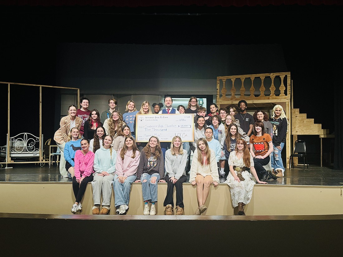 Attorney Jack Cook presents the Seabreeze theatre department with a $10,000 donation. Courtesy photo