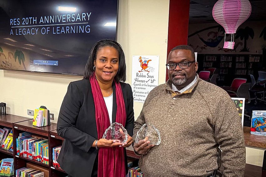 Former Rymfire Elementary School Principal LaShakia Moore and current Principal Travis Lee were honored at the schools 20th anniversary celebration on Feb. 4. Courtesy photo by Flagler Schools