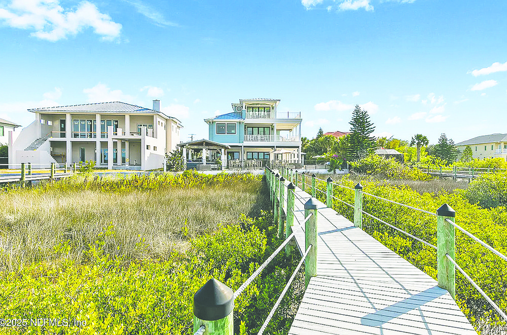 Intracoastal frontage three-story home, features five bedrooms, six full and two half-bathrooms, guest house, porches, balconies, patio, wine cellar, outdoor kitchen, pool, dock and boat house.