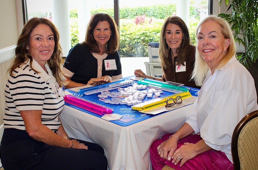 Angela Briggs, Mary Pusateri, Nancy Wolk and Lisa Ketchum start a round of mahjong at the Go for the Cure games day.