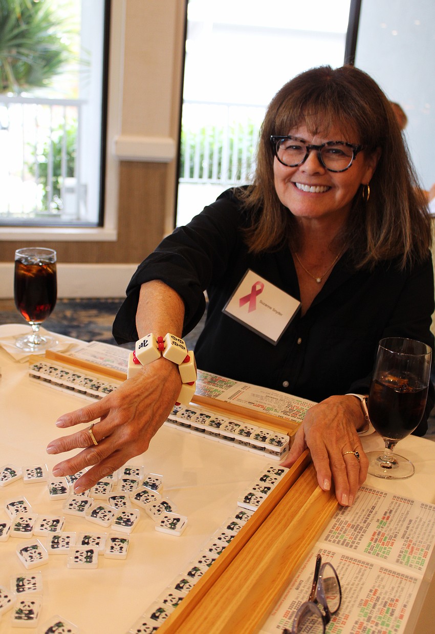 Suzanne Snyder shows off her mahjong tile bracelet.