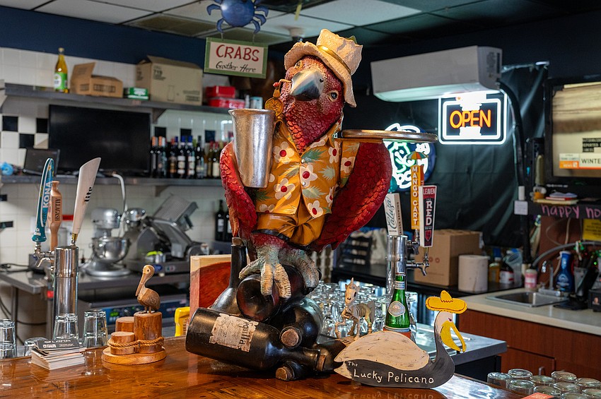 Lucky Pelican's colorful bar mascot keeps watch over the bustling space — a playful emblem of the restaurant's coastal charm. Lucky Pelican's colorful bar mascot keeps watch over the bustling space — a playful emblem of the restaurant's coastal charm.