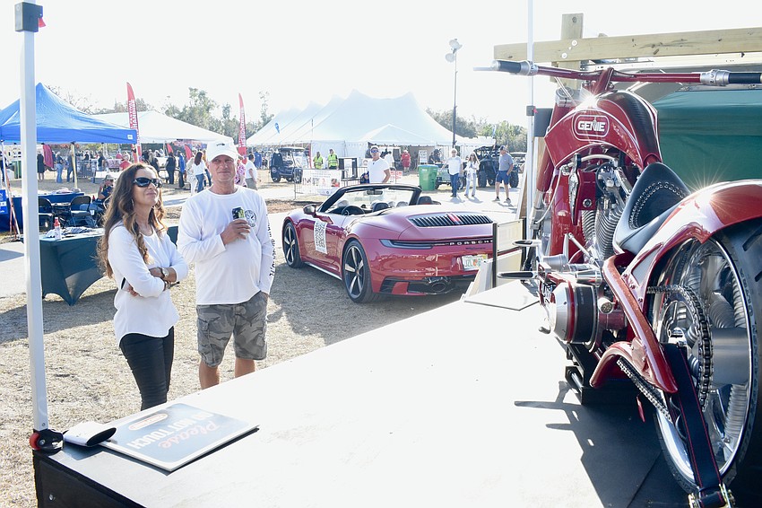 Crystal and Mark Jacobs look at the bike of Paul Teutul Jr., one of the stars of the reality television series 