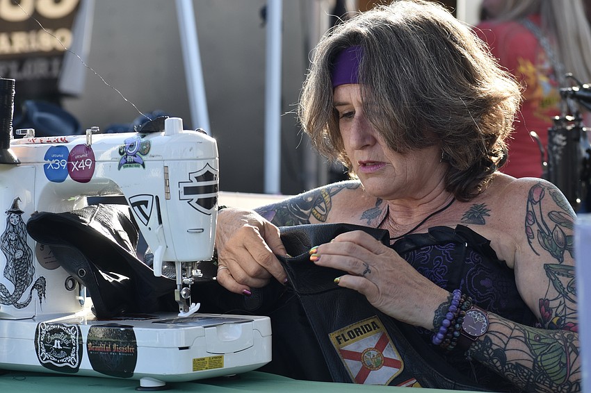 Heather Baylor sews a garment at the Stitchin B1tch tent.