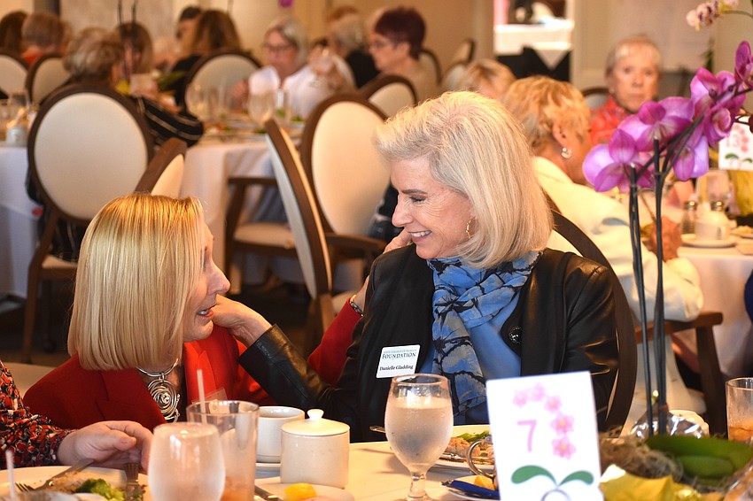 Sandy Keir, president of the Palm Aire Women's Club, introduces herself to Danielle Gladding, a board member of the State College of Florida Foundation. Gladding says she loves the club's mission and used to be a member of the country club so she feels she is at home.