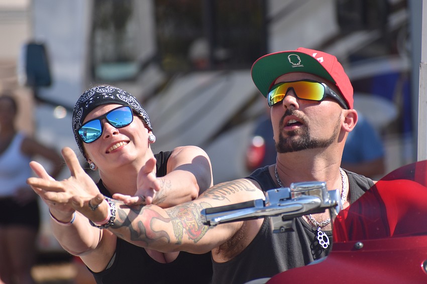 Theresa McLain and Kenny Smith reach out to catch a beanbag durig the Biker Rodeo Games.