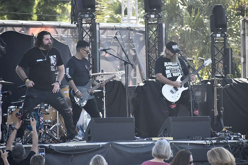 Ben Browning, Marc Bernuy and Rob Marlnee of Downsyde Up 90's Rewind perform on stage.