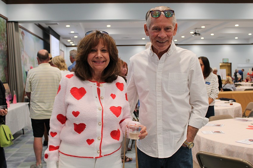 Pam and Steve Fasolino check out the art at St. Mary's Valentine's Day art show this year, the first time the art showcase is open to the public.