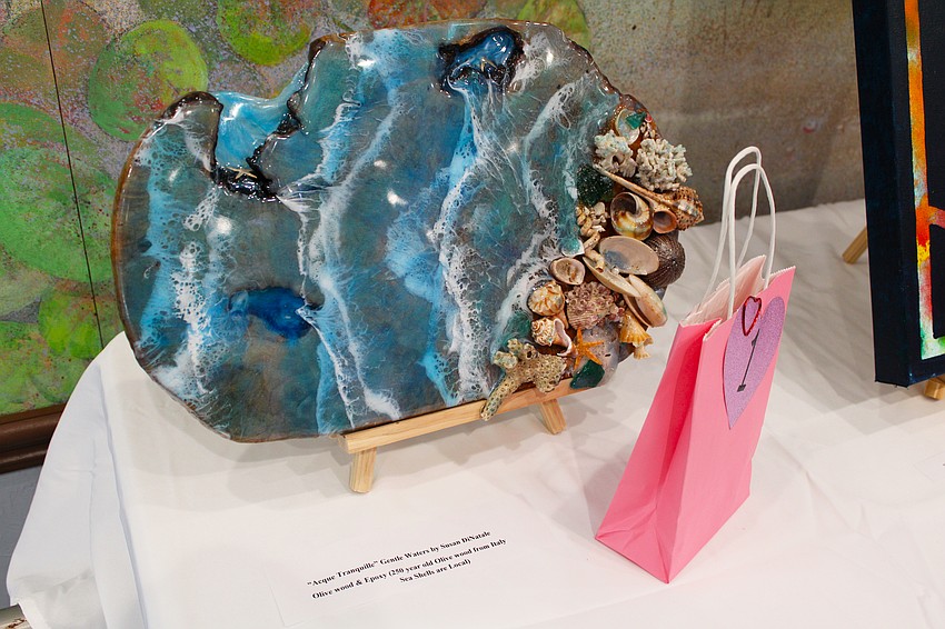 This multi-media art piece by artist Susan DiNatale caught the attention of many attendees at the Women's Guild Valentine's Day art show. The piece incorporates locally sourced seashells and 250-year-old olive wood from Italy and is titled, 