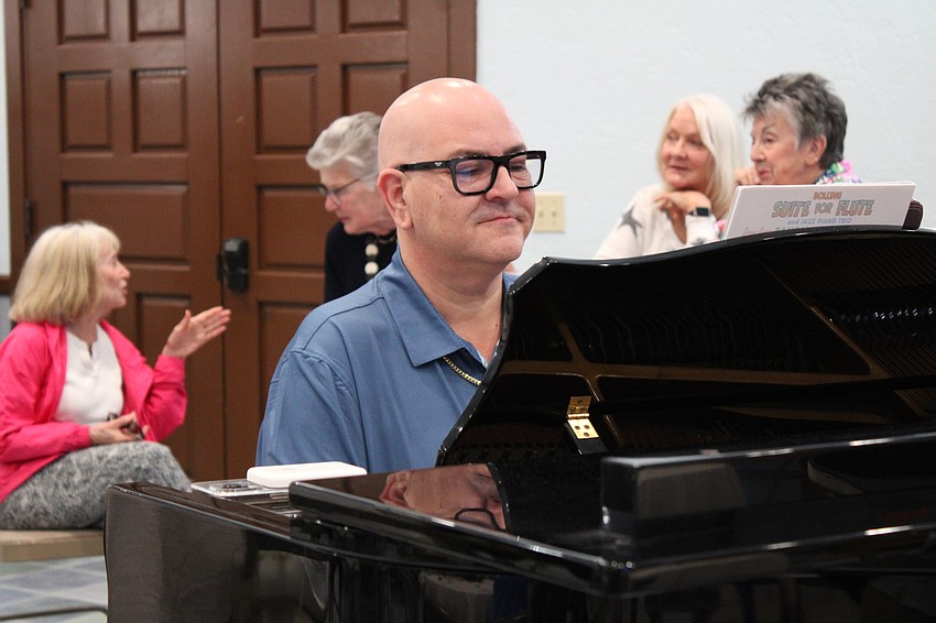 St. Mary, Star of the Sea, Catholic Church Director of Music Greg Murray plays at the Women's Guild art showcase.