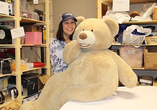 Julia Graziano, co-chair of this year's Royal Rummage Sale, shows some of the adorable items to be found at the upcoming sale.