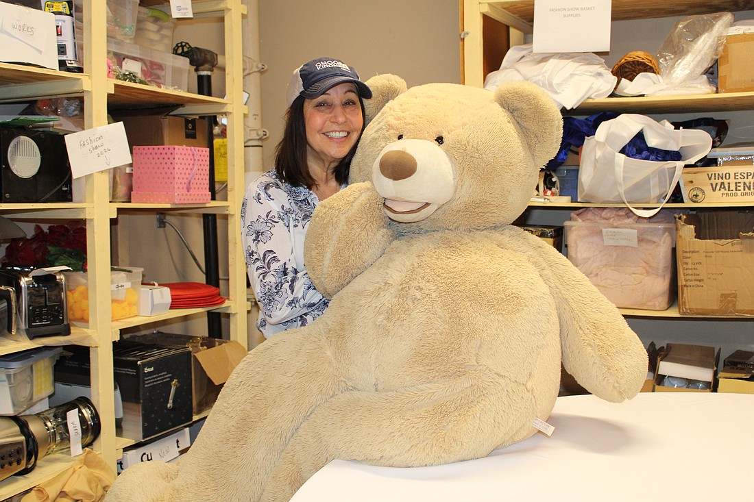 Julia Graziano, co-chair of this year's Royal Rummage Sale, shows some of the adorable items to be found at the upcoming sale.