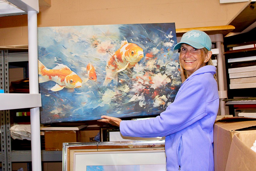 Women's Guild member Terri Leonard, volunteering in the art department for the upcoming Royal Rummage Sale, says she appreciates the fun of socializing at the sorting days.