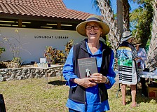 Nancy Prendergast walks away from the annual Longboat Library book sale happy with her find of a book by Jenny Lawson.