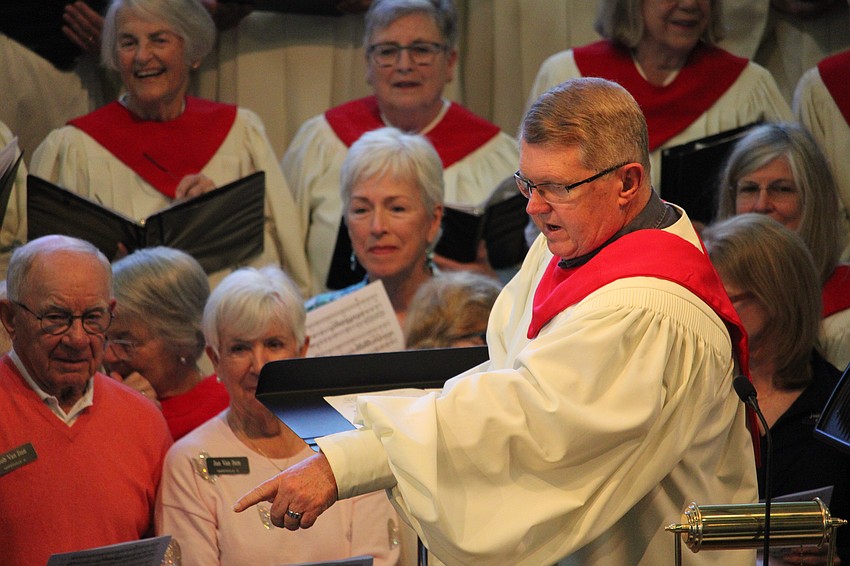 Director of Music Robert Romanski offers direction as singers find their spots on stage.