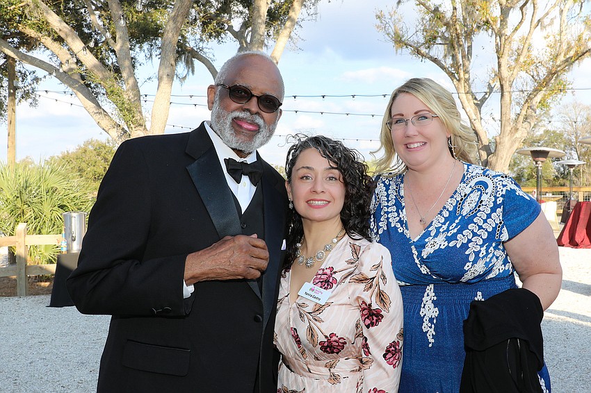 Board member Dr. Washington Hill, Yanira Castro and board member Tiffany Mangold.