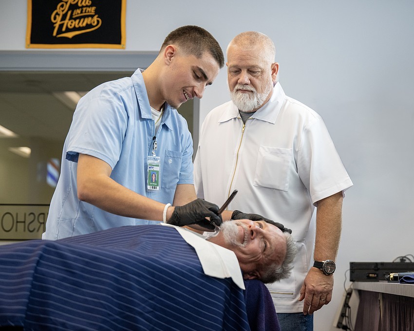 Student barber Luka Mangus refines razor technique under the watchful guidance of instructor Shane Lindergren. His father, Ross, serves as the day’s model.
