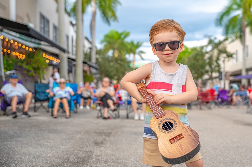 A young Music on Main fan tunes into the beat on Lakewood Ranch Main Street, where monthly block parties mix live music with pure community charm. A young Music on Main fan tunes into the beat on Lakewood Ranch Main Street, where monthly block parties mix live music with pure community charm.