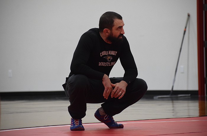 Coach Felix Osuna-Cotto oversees a Feb. 17 practice for Cardinal Mooney wrestling. He helped found the program last year, and in Year 2, the Cougars are poised to have multiple state qualifiers.