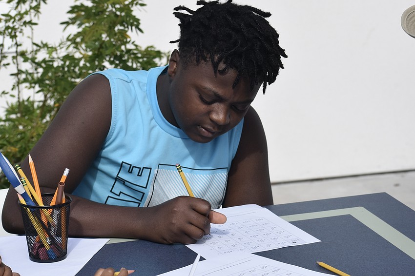 Sixth grader Anthone Johnson completes the assignment.