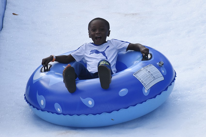Preschooler Adis Johnson heads down the slide.
