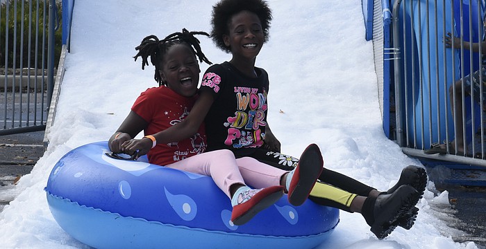 Fourth grader A’Nylah Johnson and third grader Dariana Mills head down the slide.