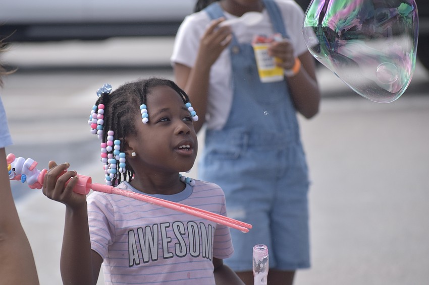 Kindergartener Ny'Arii Randolph enjoys blowing bubbles.