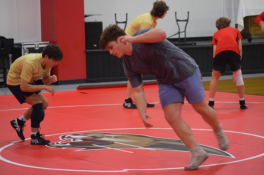 Blake Roulund (right) practices with the team before Feb. 18's FHSAA Class 1A-District 11 IBT championship. Both Will Schenerlein and Felix Osuna-Cotto credit him as a tireless advocate for the addition of the school's wrestling program.