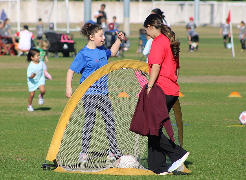 Izzie Wagar celebrates a goal with her buddy, LECOM student Arshia Arora.