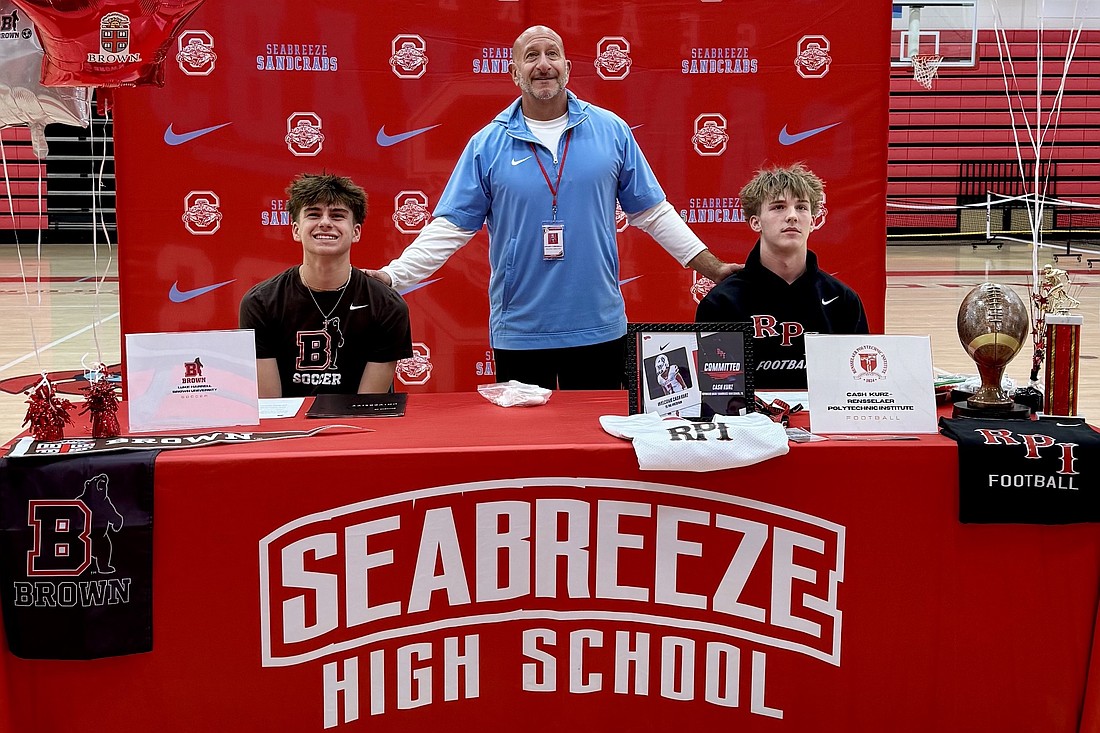 Seabreeze soccer player Luke Harrell, who signed with Brown; athletic director Anthony Campanella; and football player Cash Kurz, who signed with Rensselaer Polytechnic Institute. Courtesy photo by Elaini Harrell