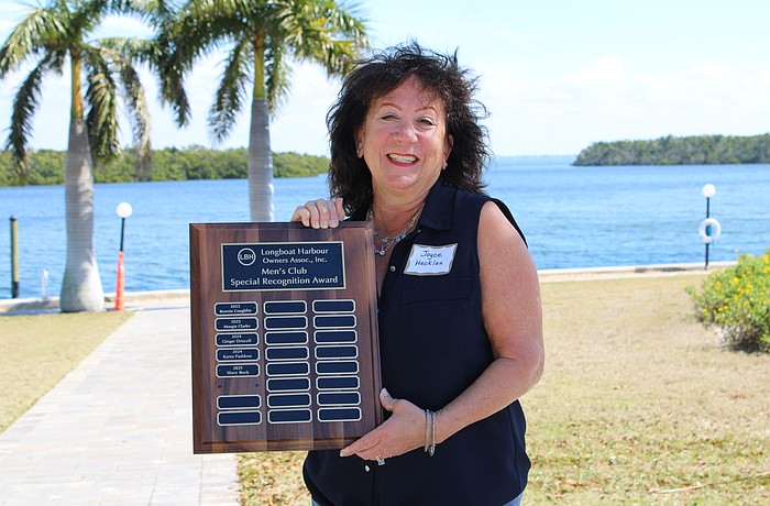 Joyce Hecklau, who played essential roles in planning Longboat Harbour's change of watch and holiday festivities, earned the title of Woman of the Year.