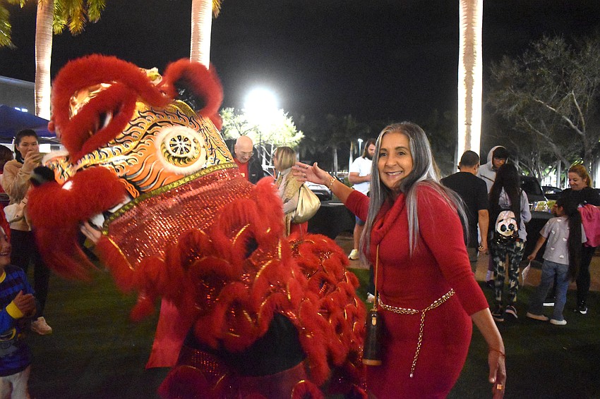 Sarasota's Teresa Pimentel poses for a photo with a lion from  Mt. Song Martial Arts Academy.