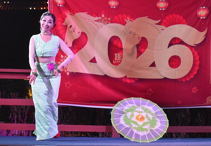 Ping Wang of Tampa Sunshine Dance Group performs an ethnic dance of the Zhuang and Dai people at the Lunar New Year Celebration.