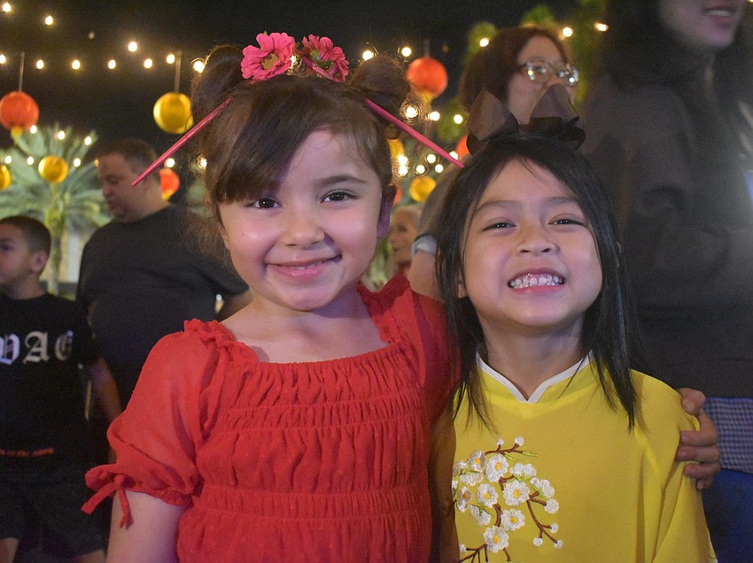 Sarasota's Amirah El Mohtar and Parrish's Maya Bui enjoy watching the performances and running around together even though they had never met before the Lunar New Year Celebration.