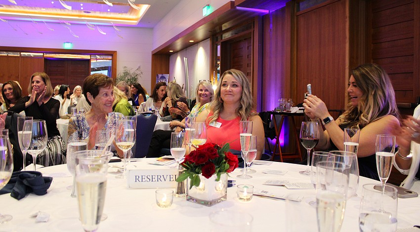 Jessica Ryherd, executive director of Feeding Empty Little Tummies, Inc., finds out her organization would be receiving the $100,000 contribution from the inaugural Longboat Key 100 drive.