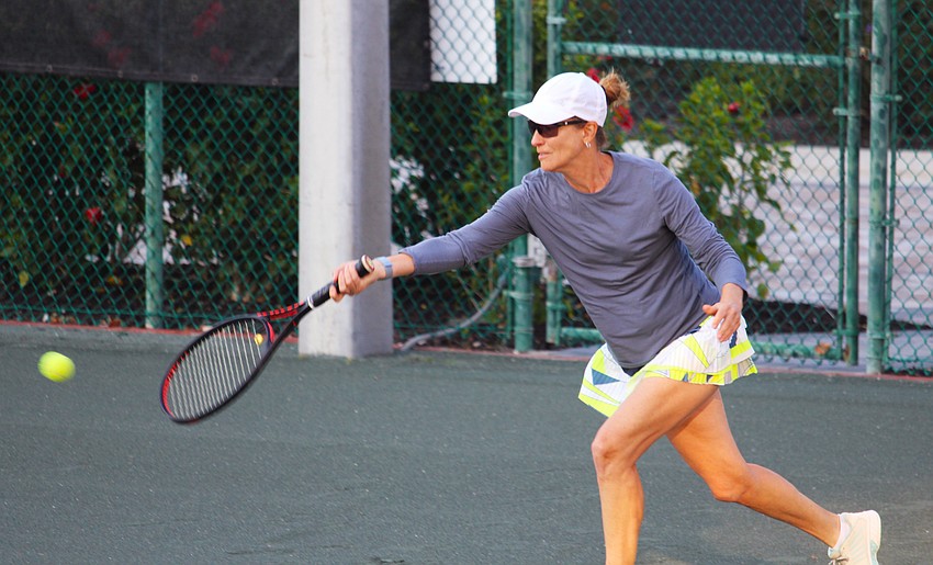Susan Friedman races to try to return a volley at a Feb. 15 tennis social at The Sanctuary at Longboat Key Club Community Association.