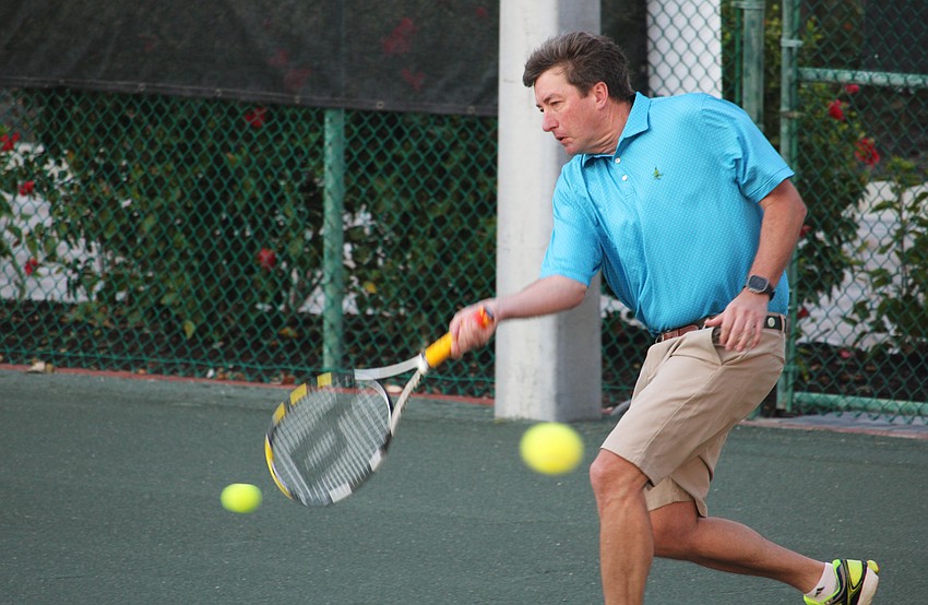 Ken King, joined by family members Kelly and Knox King, keeps up with the fast pace of a doubles warmup at the Feb. 15 tennis social.