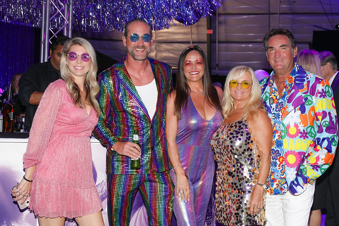 Melissa Douberly, Tyson Babb, Lisa Jayne Warren-Wallace and Gina and David Warren dig the vibe of the Studio 54 theme and the cocktail hour.