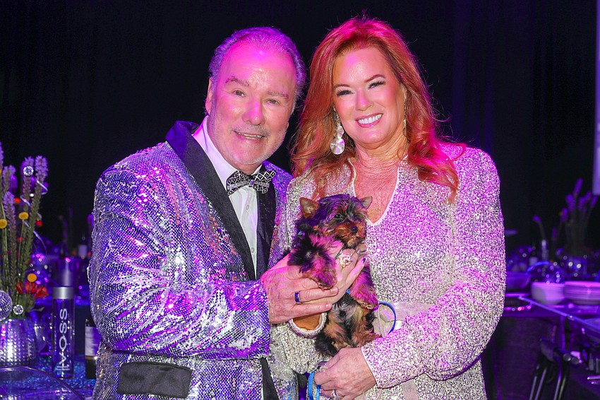 Michael and Terri Klauber with the most popular auction item on the list.