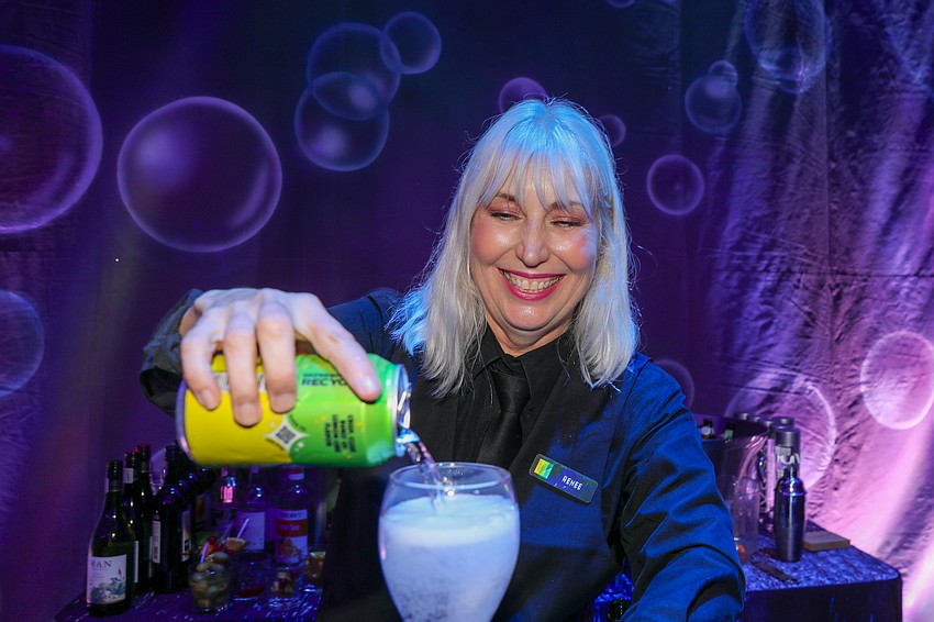 Renee from Michael's On East serves up some pop with her signature smile.