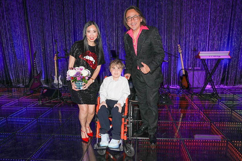 Linda and Dr. Thomas Doan with this year's recipient, Keegan Hipsher, who just found out that his wish for a trip to Switzerland has been granted.