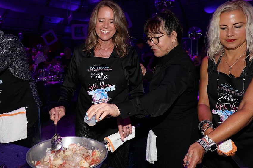 Heather Charles gets a dash of cumin for her Midnight Marrakesh fish dish.