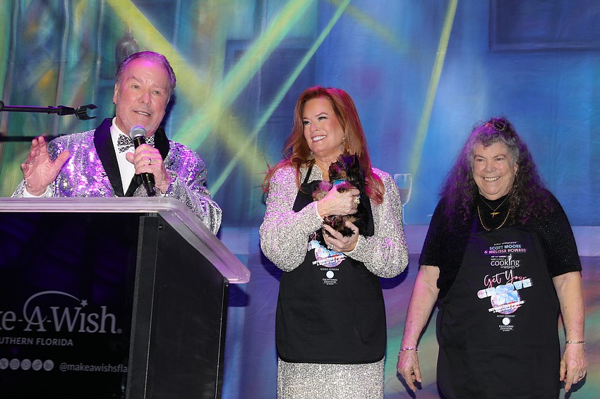 Michael and Terri Klauber with Christine Merkent and the yet unsold pup.