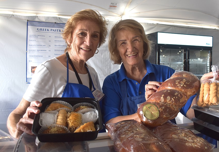 Pat Trempelas and Kalla Amoratis volunteer at the pastry booth, which includes a variety pack of sweets, Tsoureki Sweet Bread  and cookies called Koulouria.