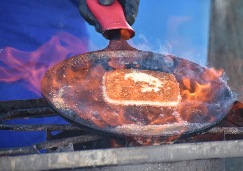 Saganaki, a Greek goat cheese, is a popular appetizer commonly pan-fried and known for its crispy exterior and melted interior.