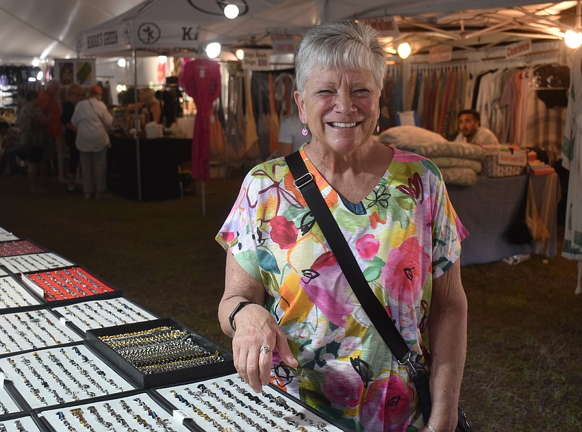 Elizabeth Robinson, who is visiting from Minneapolis, is eager to wear her new ring she purchased from one of the 30 vendors at the St. Barbara 42nd Annual Greek Festival.
