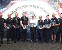 SPD Chief Rex Troche (left) and Deputy Chief Scott Mayforth (right) with (from left) Lt. Andrew Combs, Officer Nate Lynn, Officer Nick Bruno, Officer Ridge Collins, Officer Brenton Bieker, Det. Laura Bobitz and Officer Tim Dederick. They and others were involved in stopping a suicide threat on the Ringling Bridge.